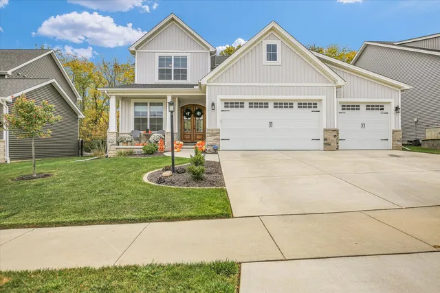 a front view of a house with a garden and yard