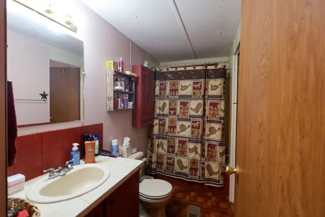 a bathroom with a sink toilet and shower
