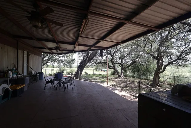 a view of a porch with chairs and a fireplace