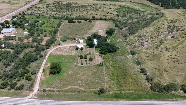an aerial view of a residential houses with outdoor space