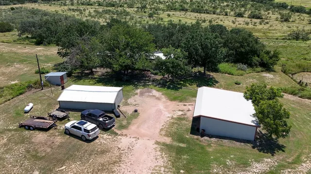 an aerial view of a house with garden space and sitting space