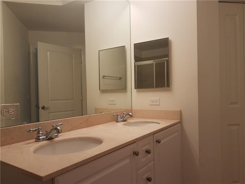 1 Renaissance Way, Unit 106 Boynton Beach, FL 33426 - Photo 27 of 31 a bathroom with a sink vanity and a mirror