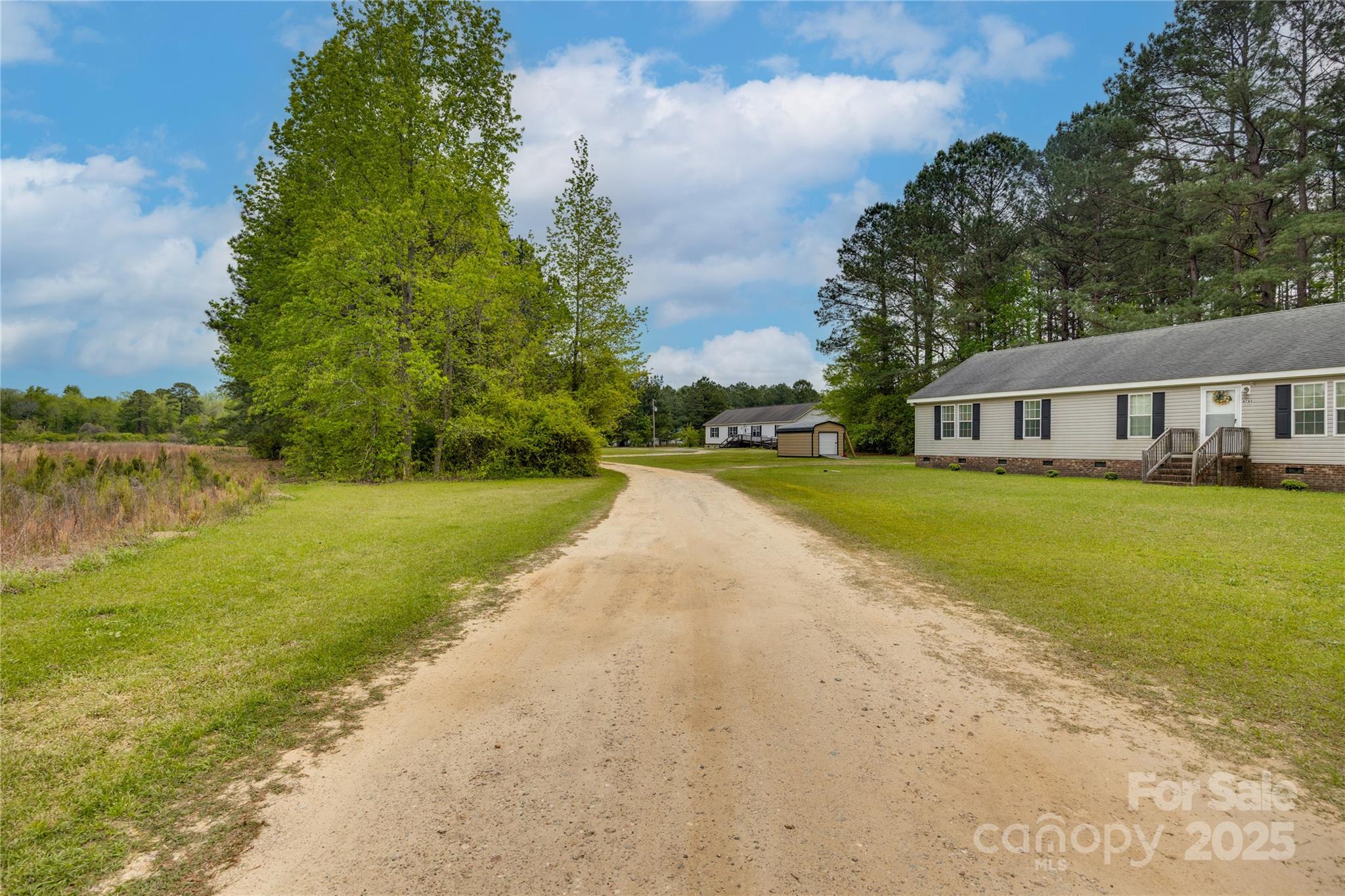 4749 Draughon Road Stedman, NC 28391 - Photo 20 of 22 a view of a house with yard and lake view