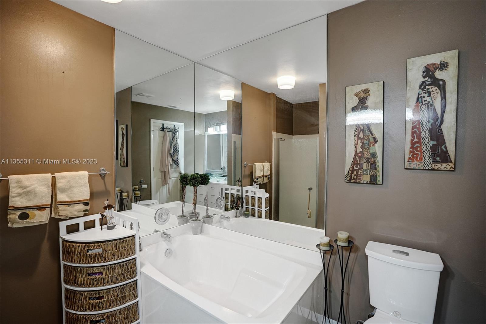 Tamarac Tamarac, FL 33321 - Photo 13 of 49 a bathroom with a sink a toilet and mirror