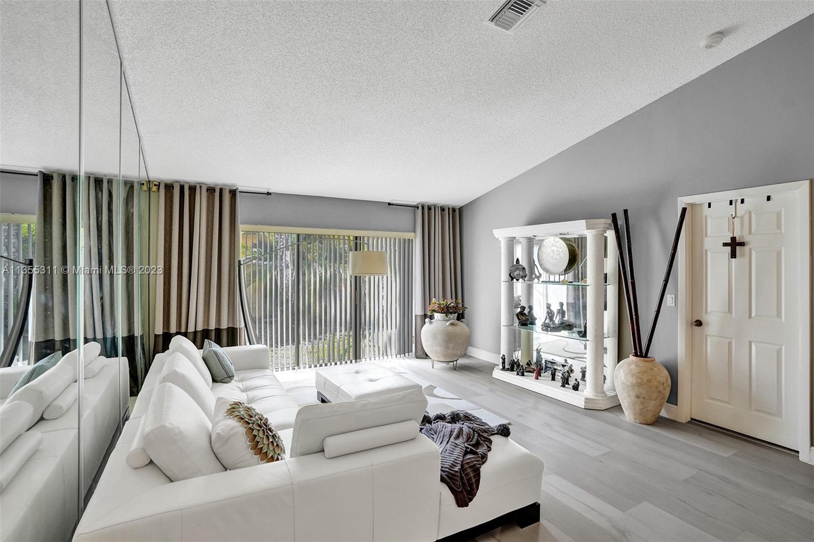 Tamarac Tamarac, FL 33321 - Photo 15 of 49 a living room with furniture and a large window