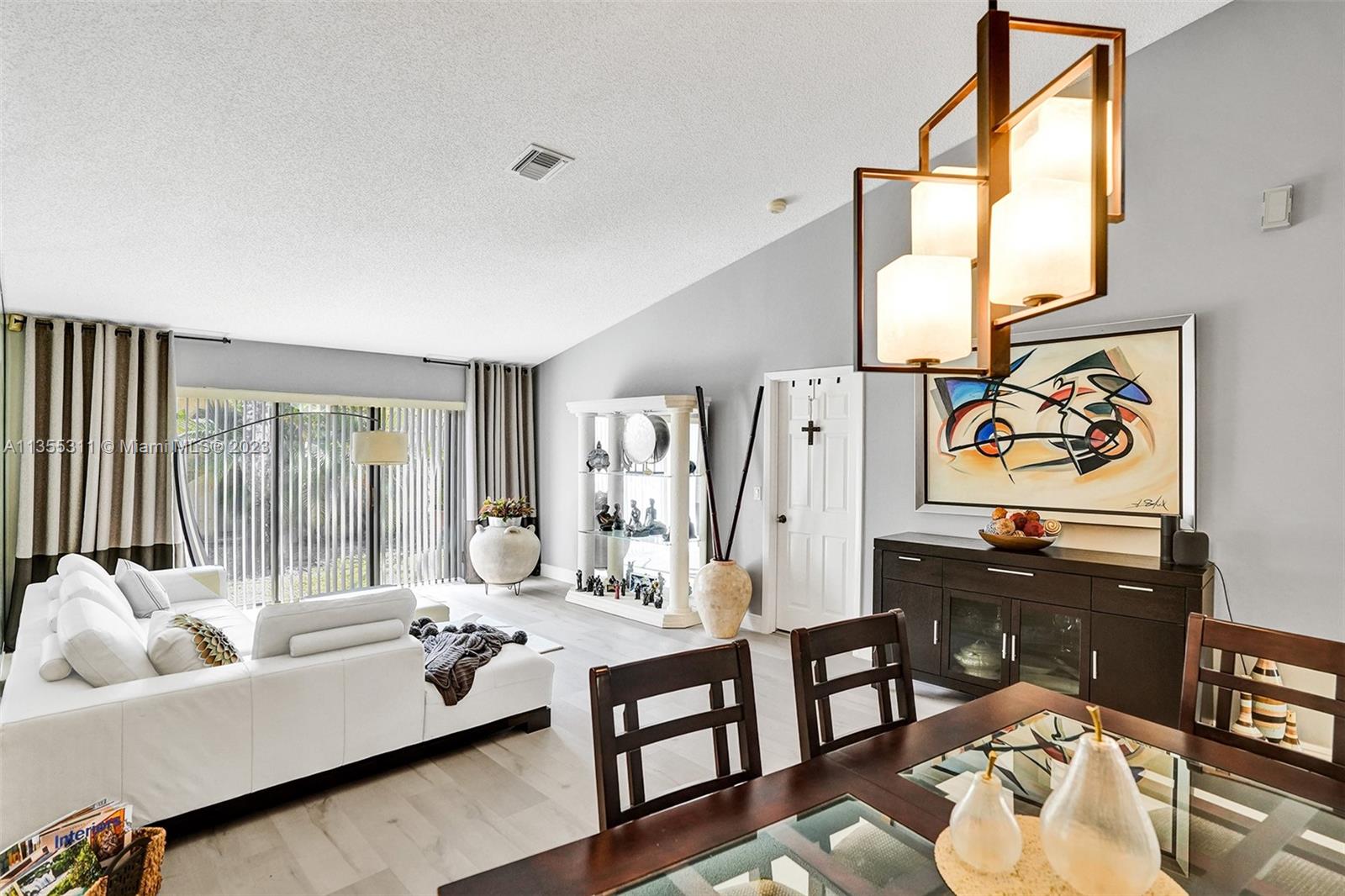 Tamarac Tamarac, FL 33321 - Photo 16 of 49 a living room with furniture and a flat screen tv