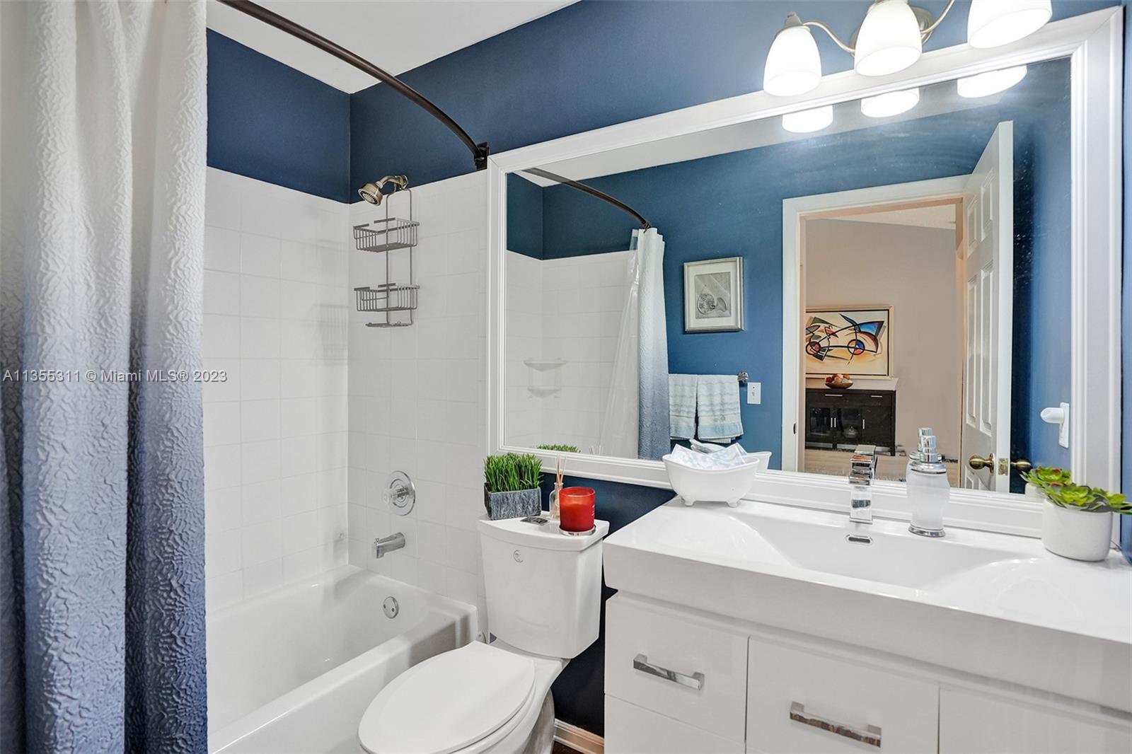 Tamarac Tamarac, FL 33321 - Photo 22 of 49 a bathroom with a sink vanity mirror and toilet