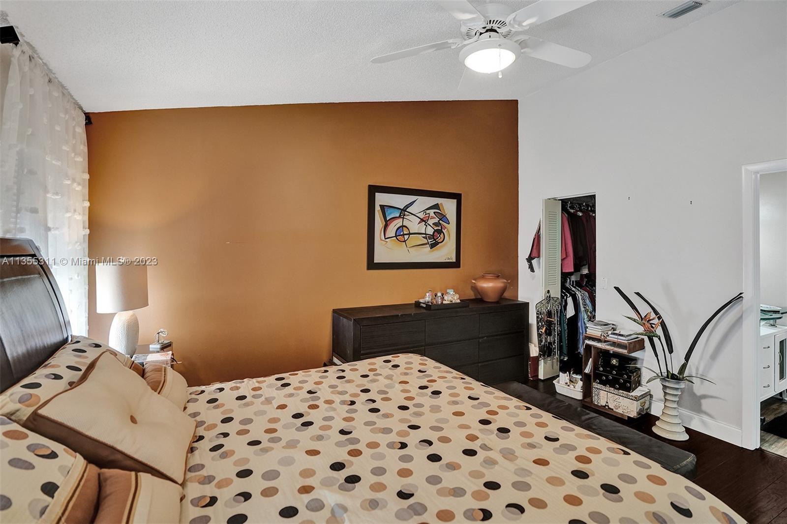 Tamarac Tamarac, FL 33321 - Photo 25 of 49 a bedroom with a bed and a chandelier