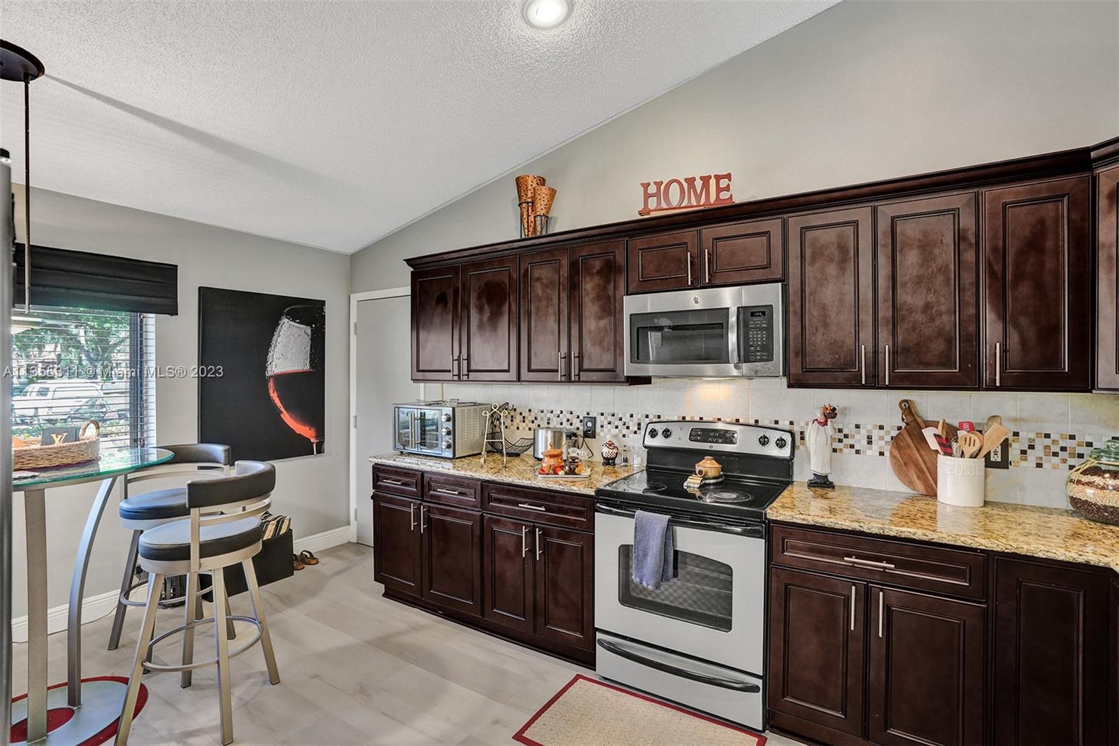 Tamarac Tamarac, FL 33321 - Photo 26 of 49 a kitchen with stainless steel appliances a stove a sink dishwasher and cabinets with wooden floor