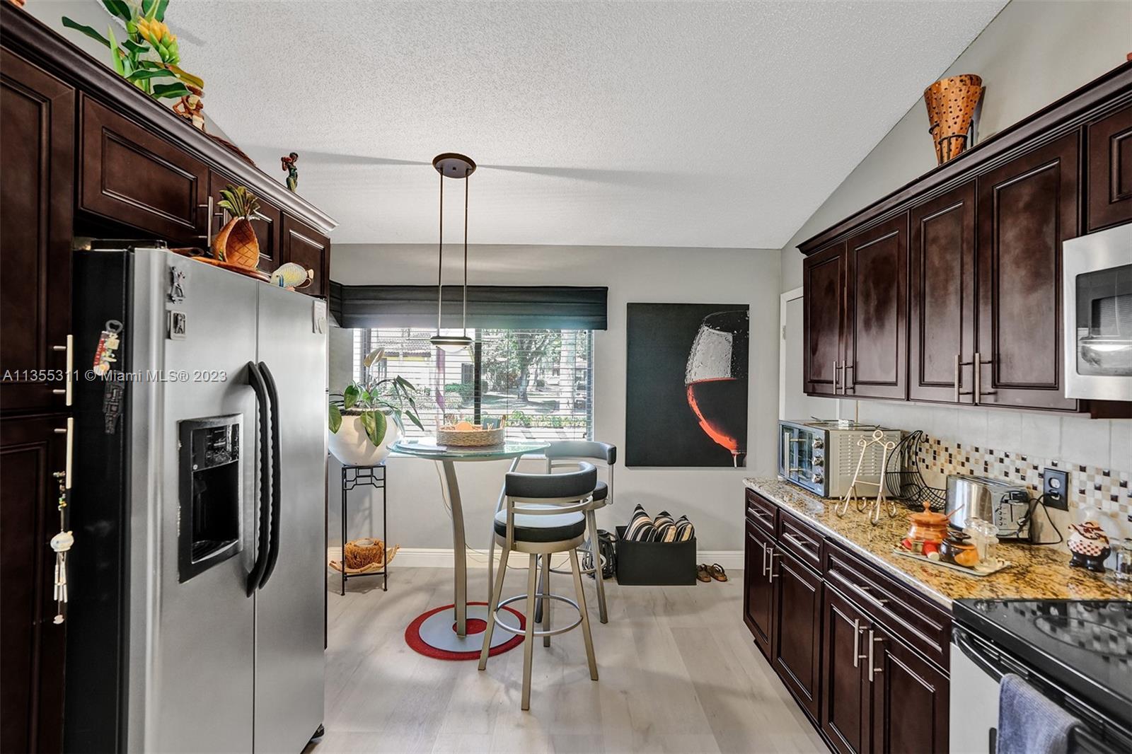 Tamarac Tamarac, FL 33321 - Photo 28 of 49 a kitchen with stainless steel appliances granite countertop a sink a stove and refrigerator