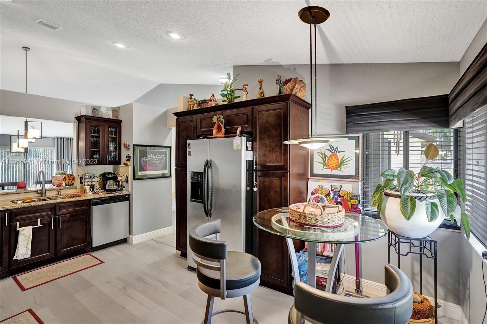 Tamarac Tamarac, FL 33321 - Photo 32 of 49 a kitchen with a dining table and chairs