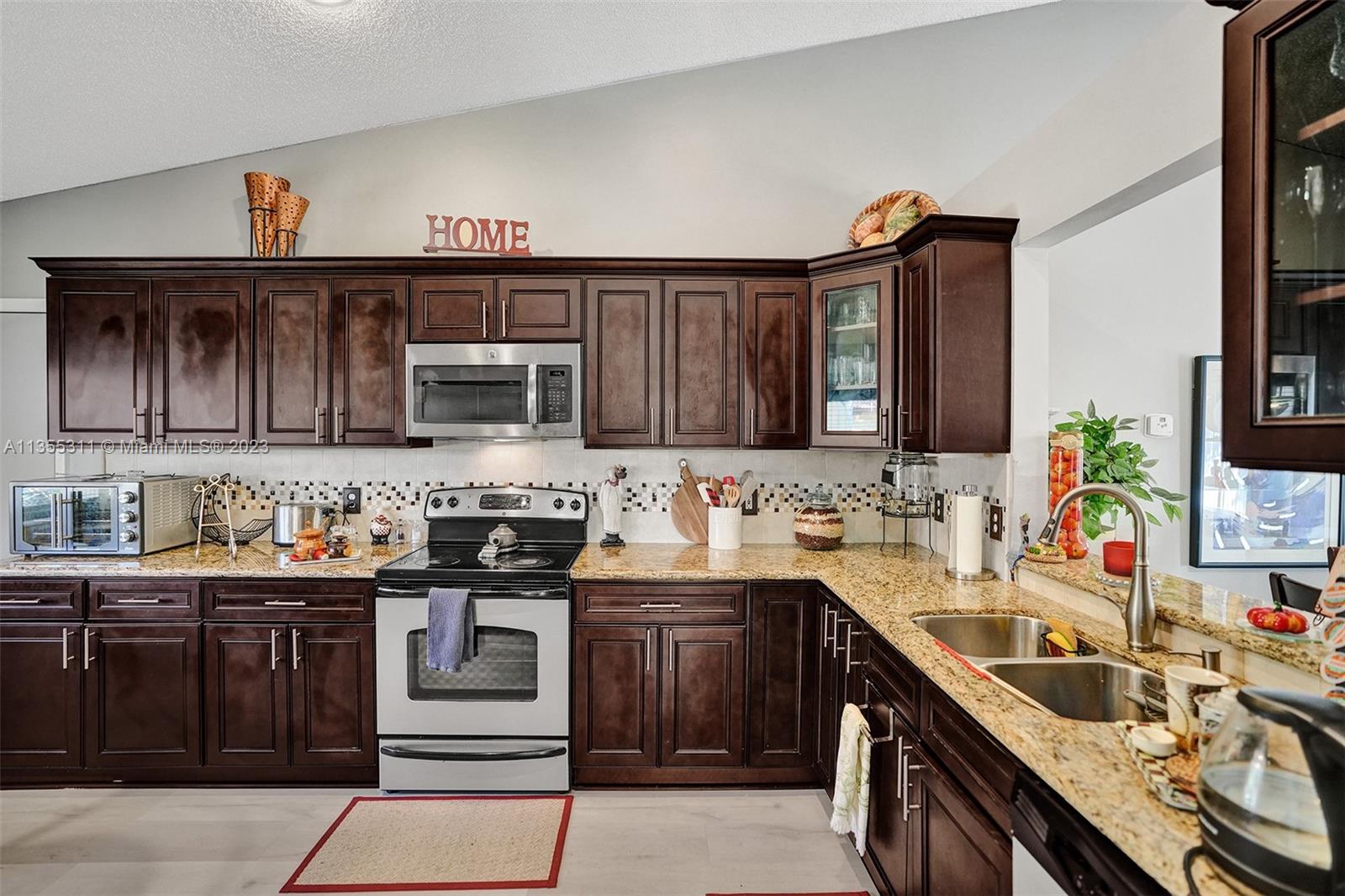Tamarac Tamarac, FL 33321 - Photo 34 of 49 a kitchen with a sink stove top oven and cabinets