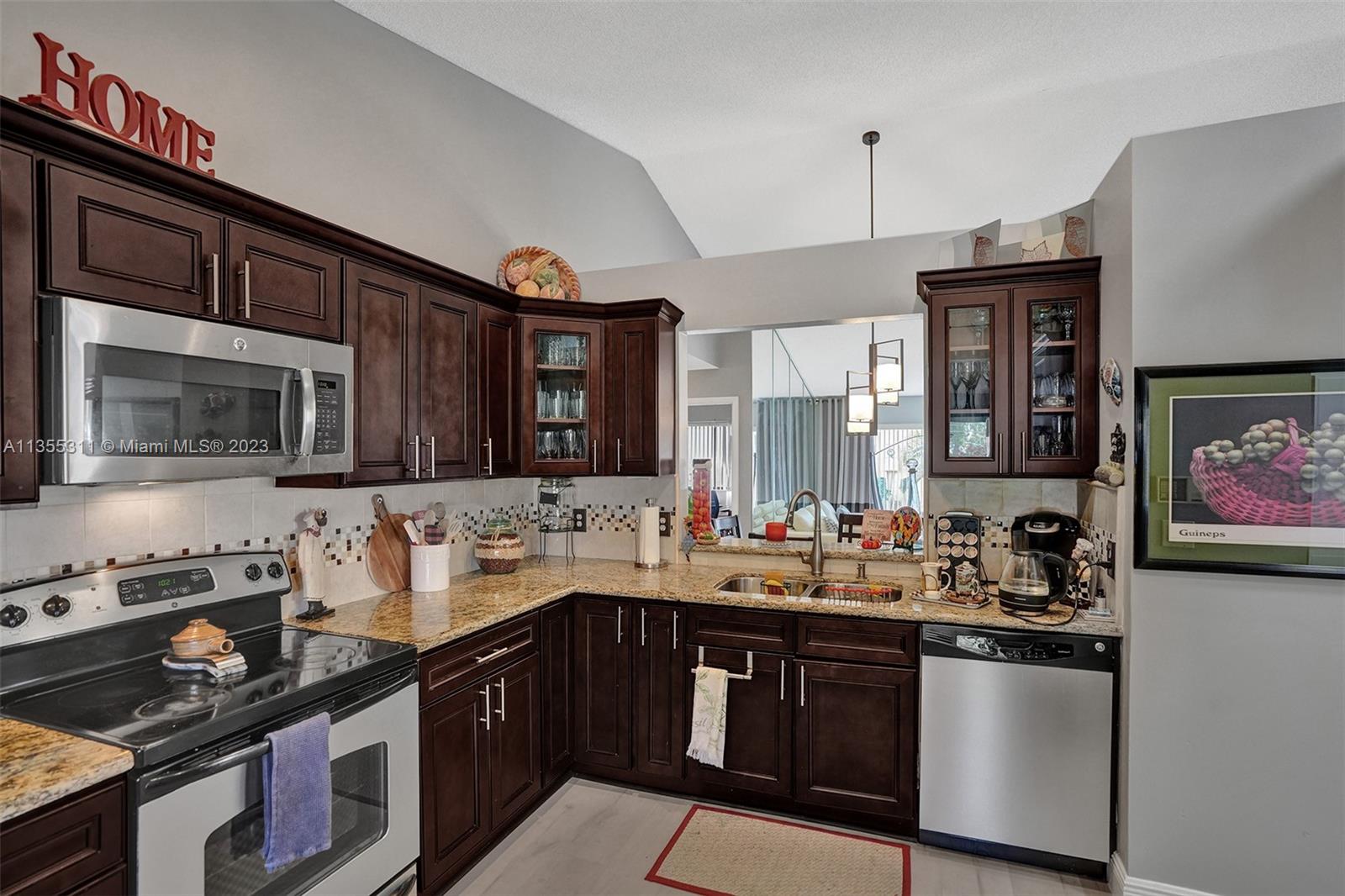Tamarac Tamarac, FL 33321 - Photo 35 of 49 a kitchen with a sink stove top oven and cabinets