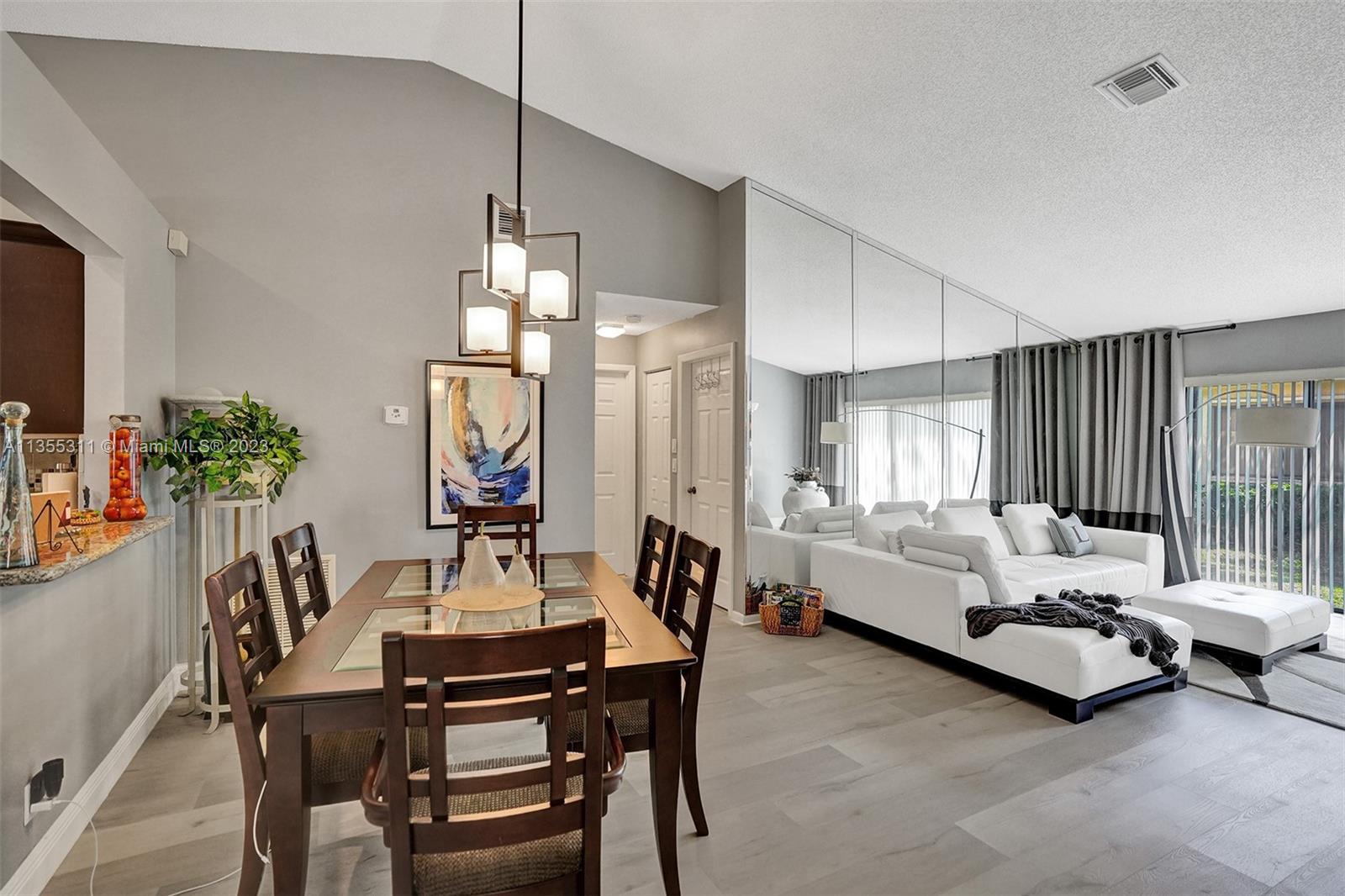 Tamarac Tamarac, FL 33321 - Photo 37 of 49 a living room with furniture and a chandelier