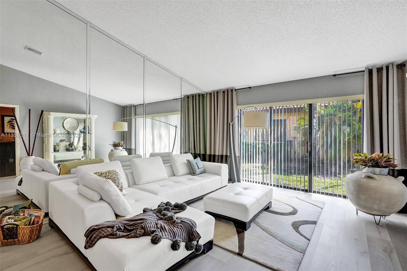 Tamarac Tamarac, FL 33321 - Photo 39 of 49 a living room with furniture and a floor to ceiling window