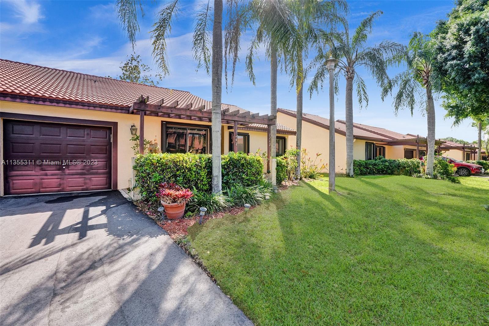 Tamarac Tamarac, FL 33321 - Photo 4 of 49 a front view of a house with garden