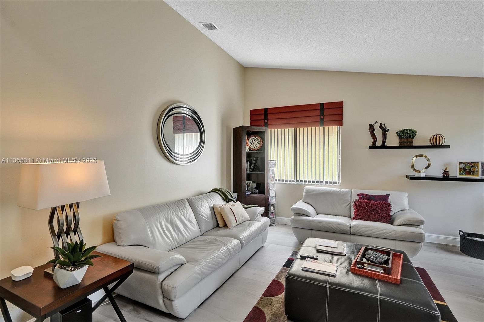 Tamarac Tamarac, FL 33321 - Photo 41 of 49 a living room with furniture and a lamp