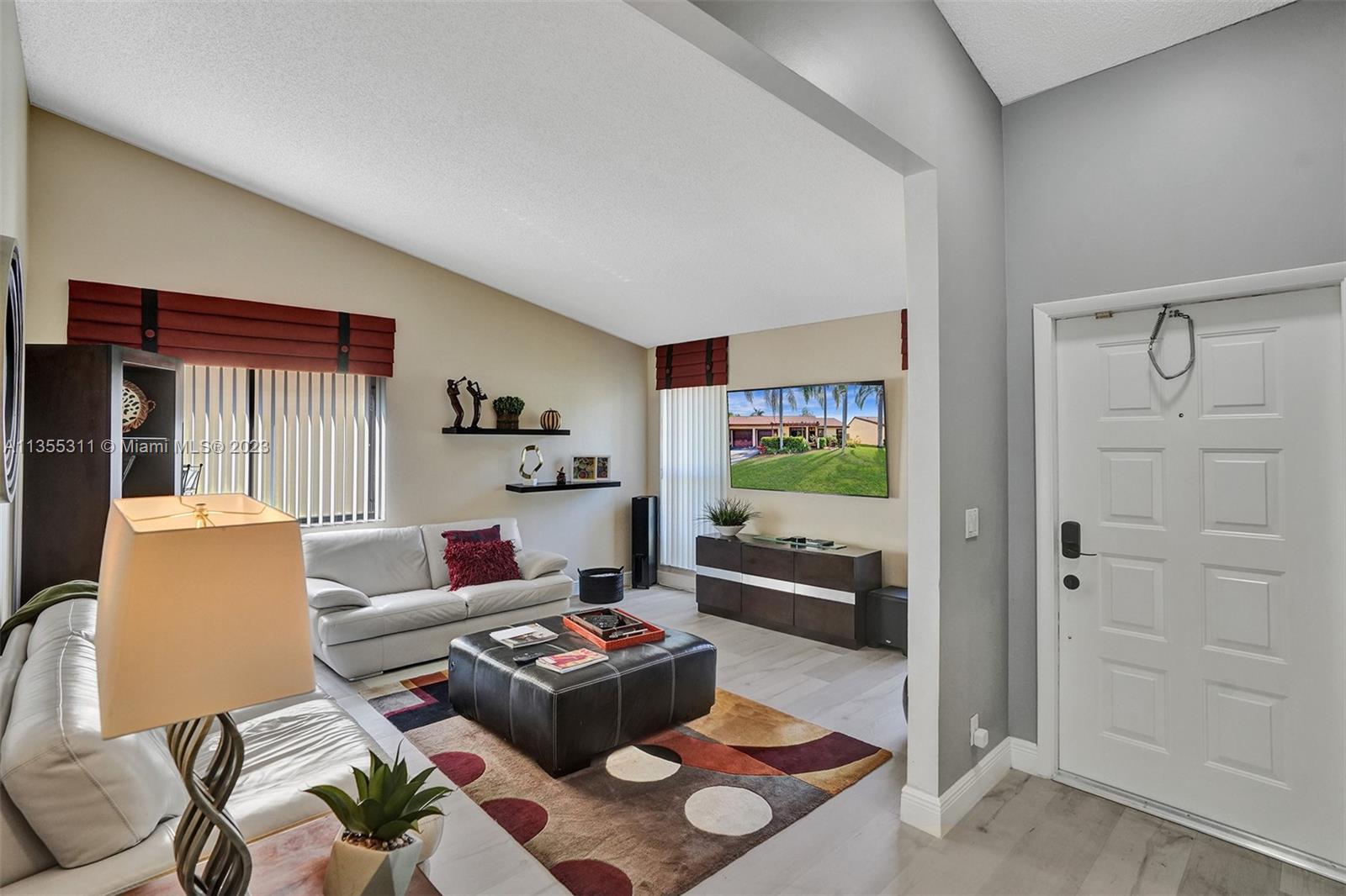 Tamarac Tamarac, FL 33321 - Photo 42 of 49 a living room with furniture and a flat screen tv