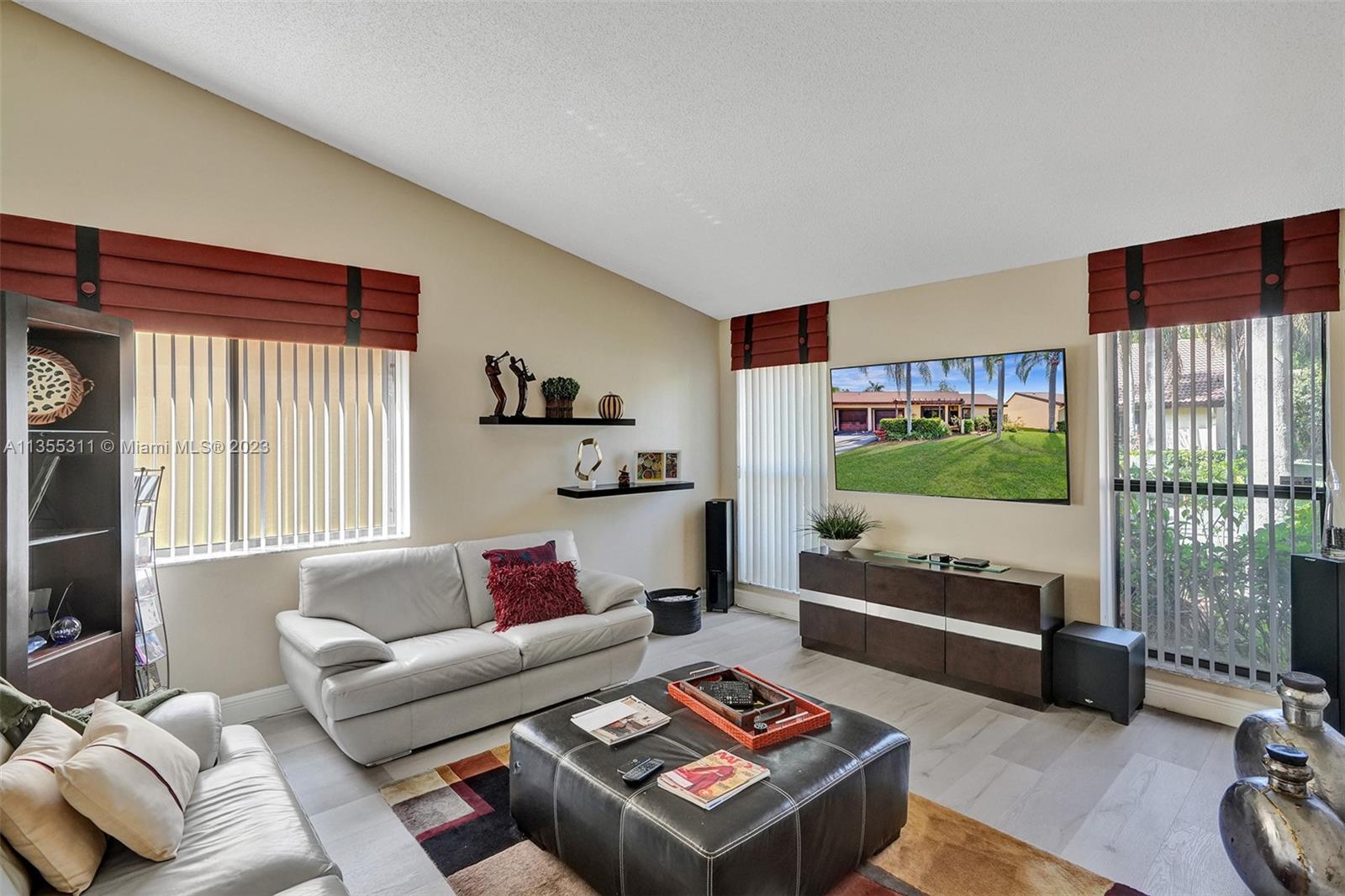 Tamarac Tamarac, FL 33321 - Photo 43 of 49 a living room with furniture and a flat screen tv