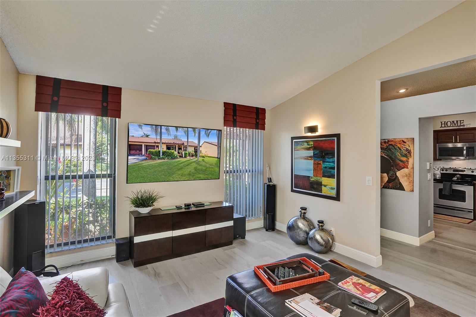 Tamarac Tamarac, FL 33321 - Photo 45 of 49 a living room with furniture and a flat screen tv
