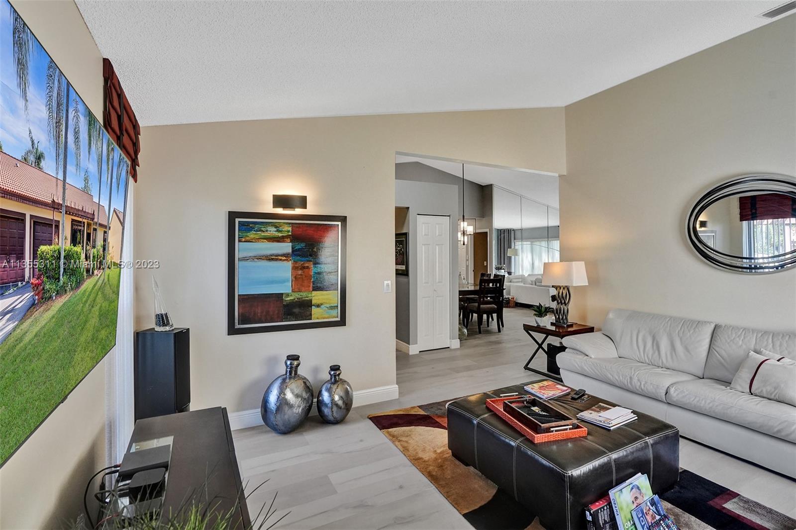 Tamarac Tamarac, FL 33321 - Photo 47 of 49 a living room with furniture a rug and a flat screen tv