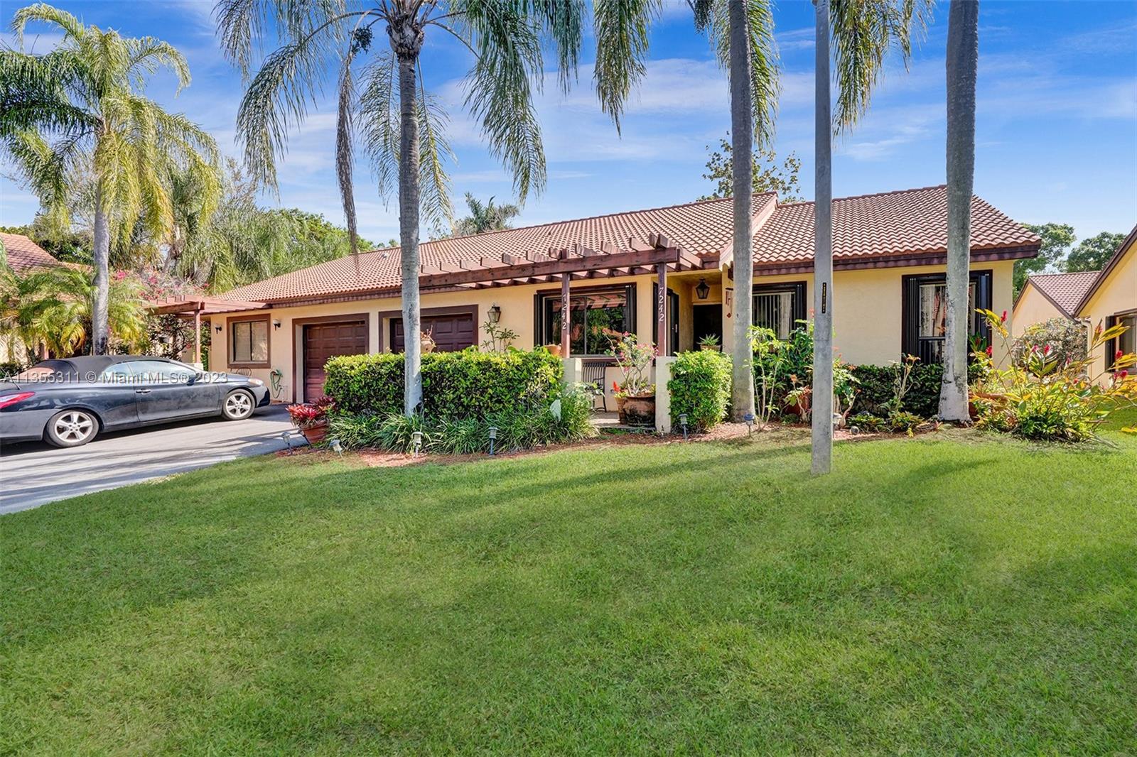 Tamarac Tamarac, FL 33321 - Photo 5 of 49 a front view of a house with a garden