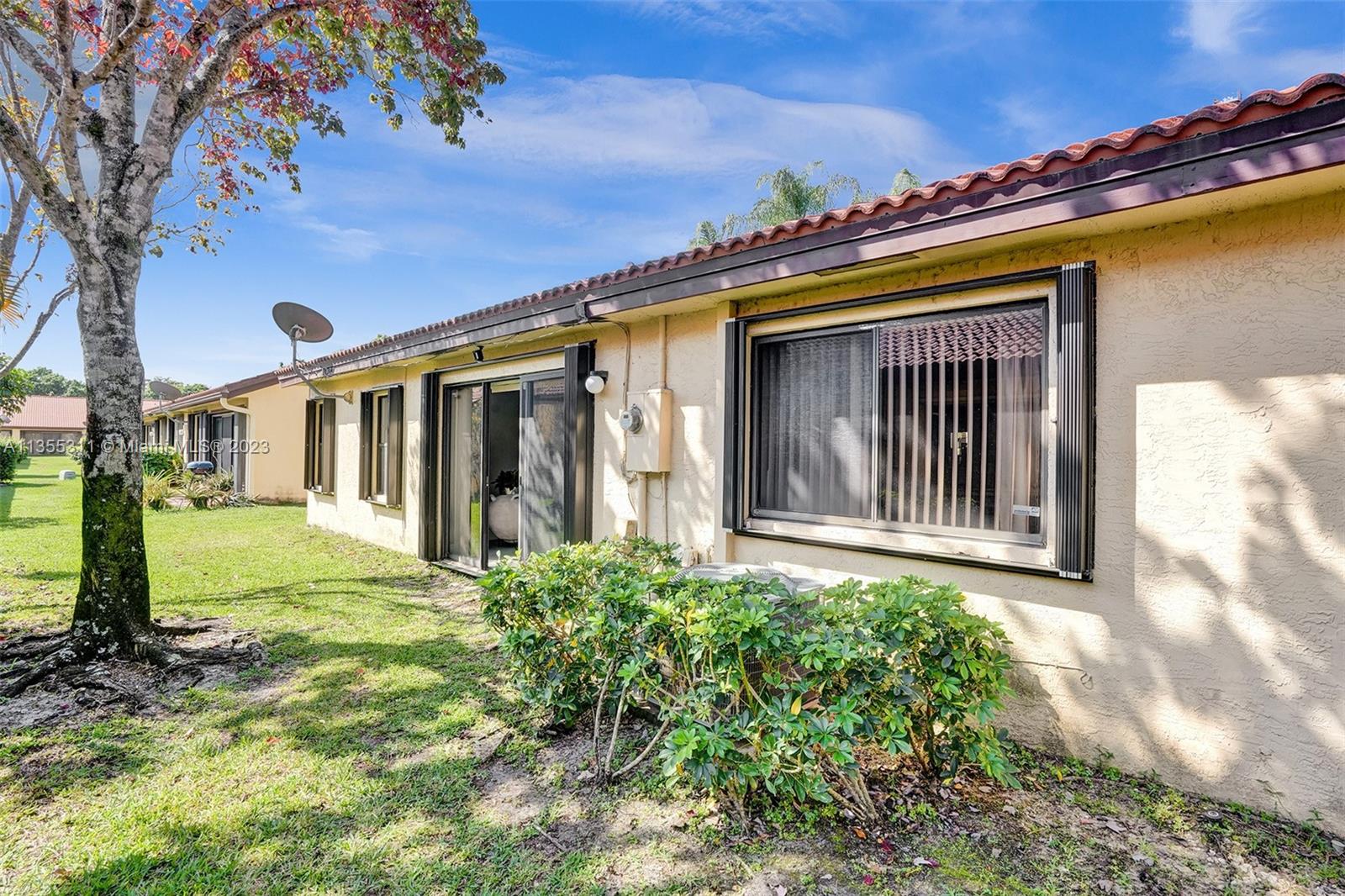 Tamarac Tamarac, FL 33321 - Photo 7 of 49 a view of a house with a small yard next to a road