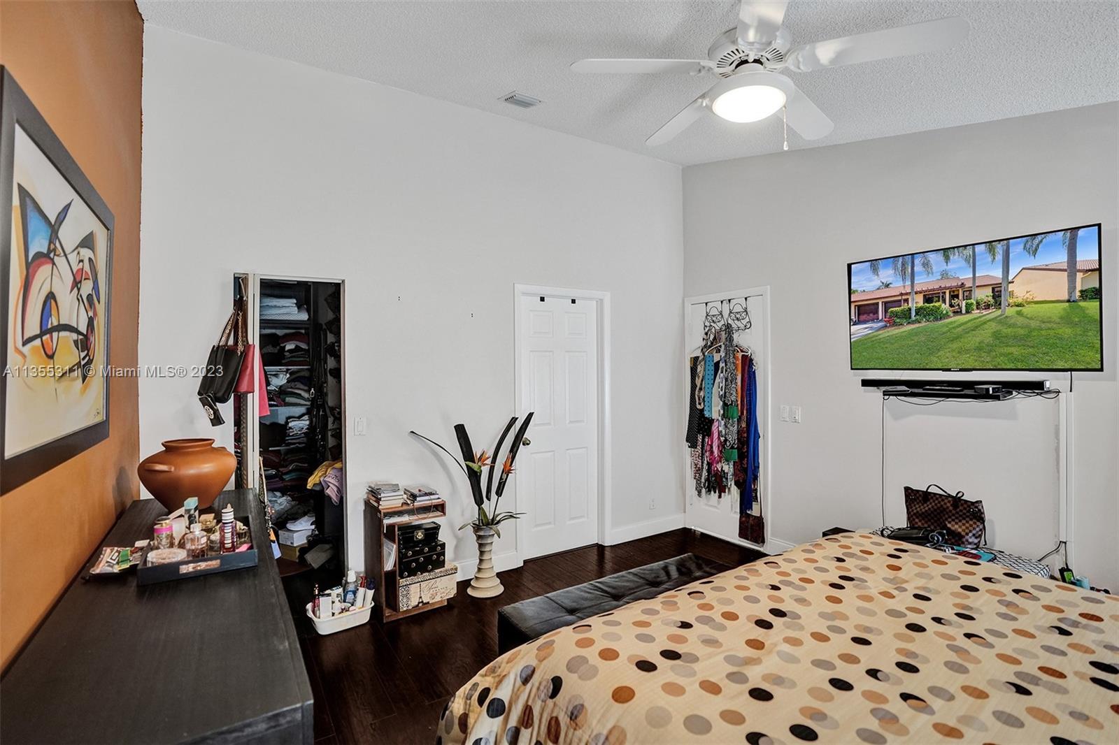 Tamarac Tamarac, FL 33321 - Photo 9 of 49 a bedroom with a bed and a chandelier