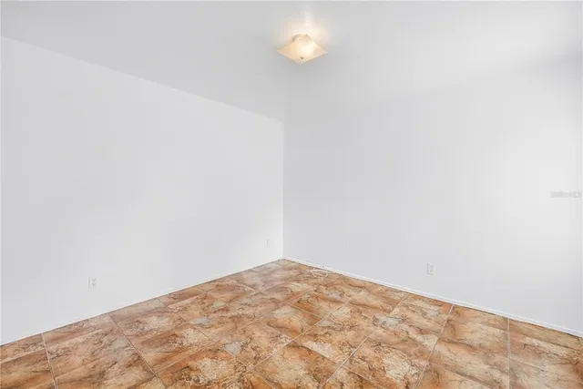 a view of a big room with closet and windows