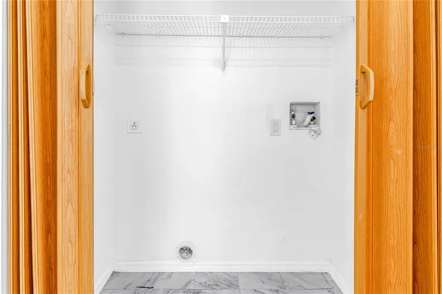 a view of a swimming pool with chairs in a patio