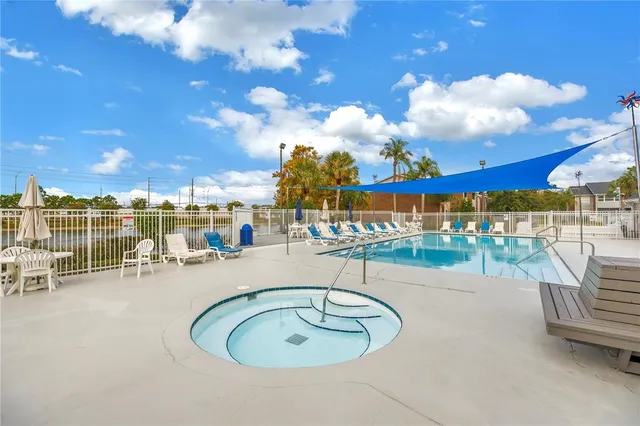 an outdoor sitting area with couch and chairs