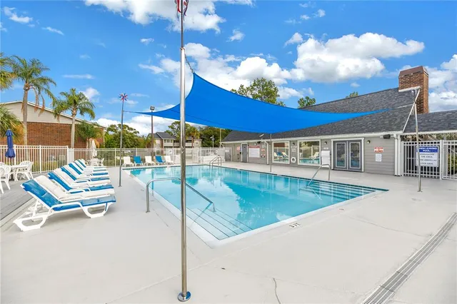a view of a swimming pool with outdoor seating