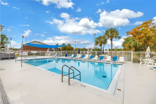 a room with furniture pool table and window