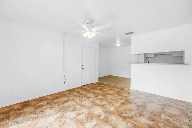 a view of a kitchen with a sink and a chandelier fan