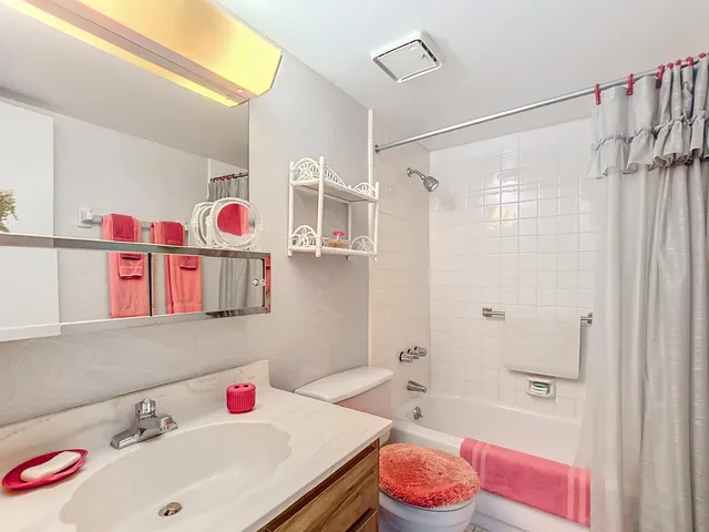 a bedroom with two beds and a large window