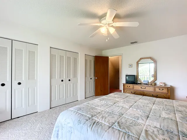 a bedroom with bed and a chandelier