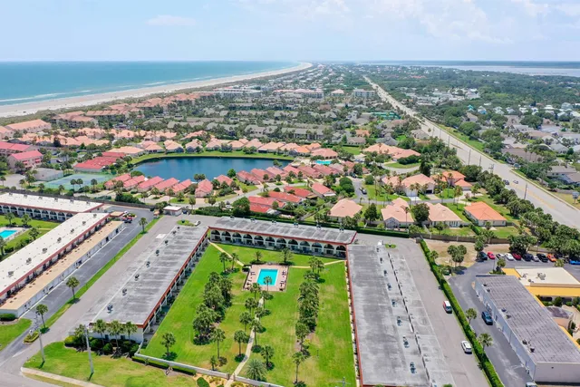 an aerial view of a resort with a swimming pool