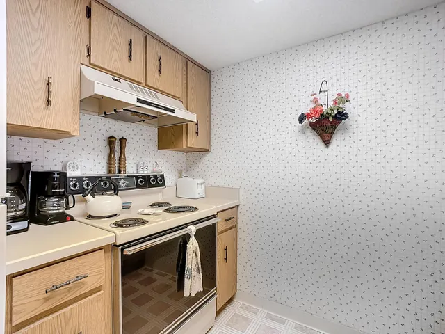 a kitchen with stainless steel appliances a sink cabinets and stove top oven