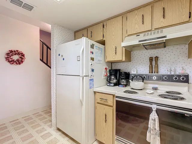 a kitchen with a sink cabinets and a wooden floor