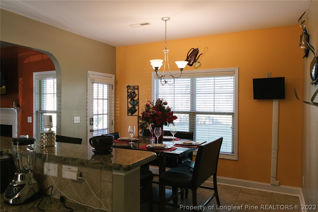 153 Shellbark Drive Spring Lake, NC 28390 - Photo 12 of 48 a view of a dining room with furniture and chandelier
