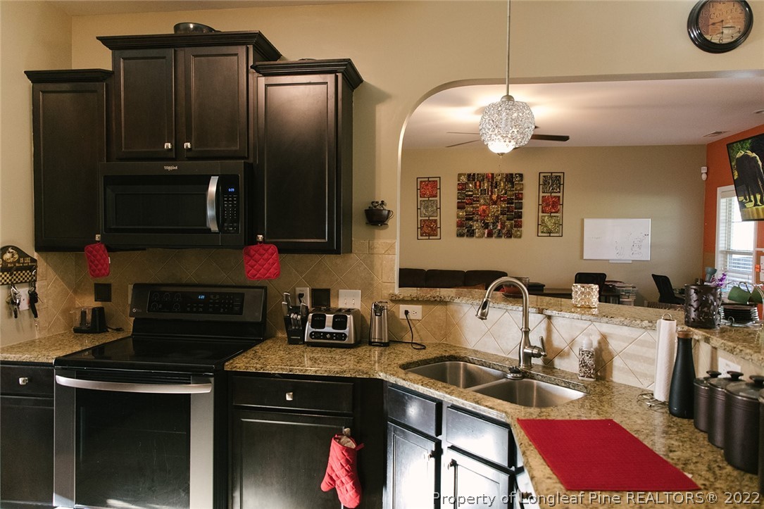 153 Shellbark Drive Spring Lake, NC 28390 - Photo 14 of 48 a kitchen with a sink stove and refrigerator