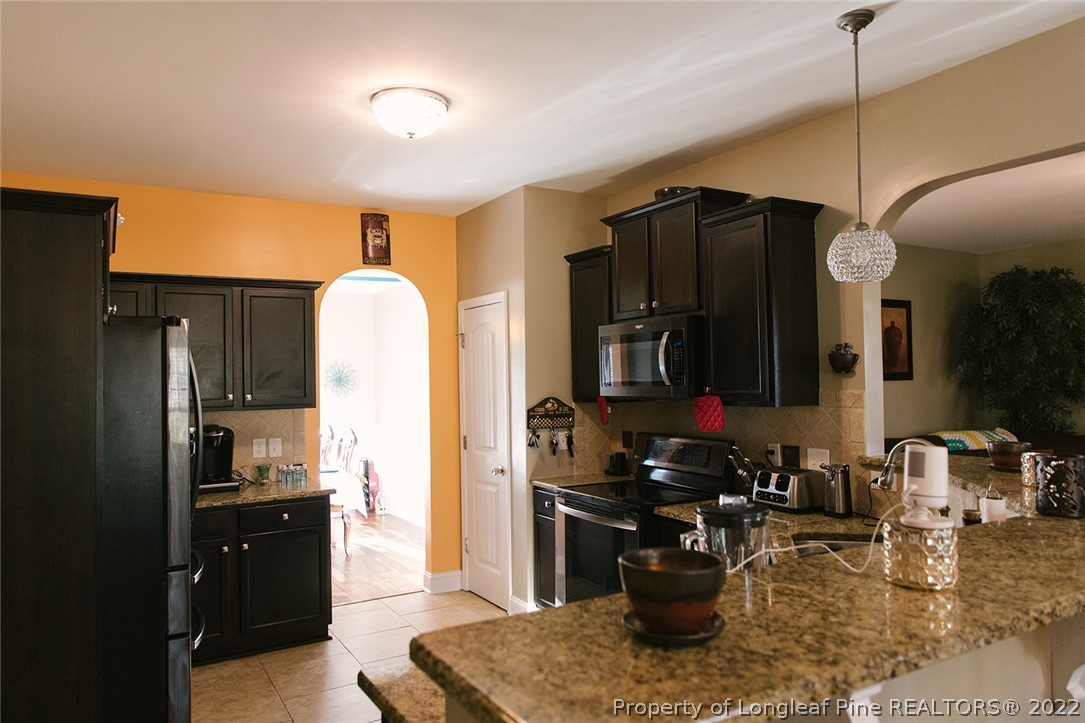 153 Shellbark Drive Spring Lake, NC 28390 - Photo 15 of 48 a kitchen with a refrigerator and a sink