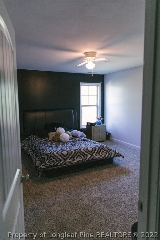 153 Shellbark Drive Spring Lake, NC 28390 - Photo 41 of 48 a bedroom with a bed and a large window