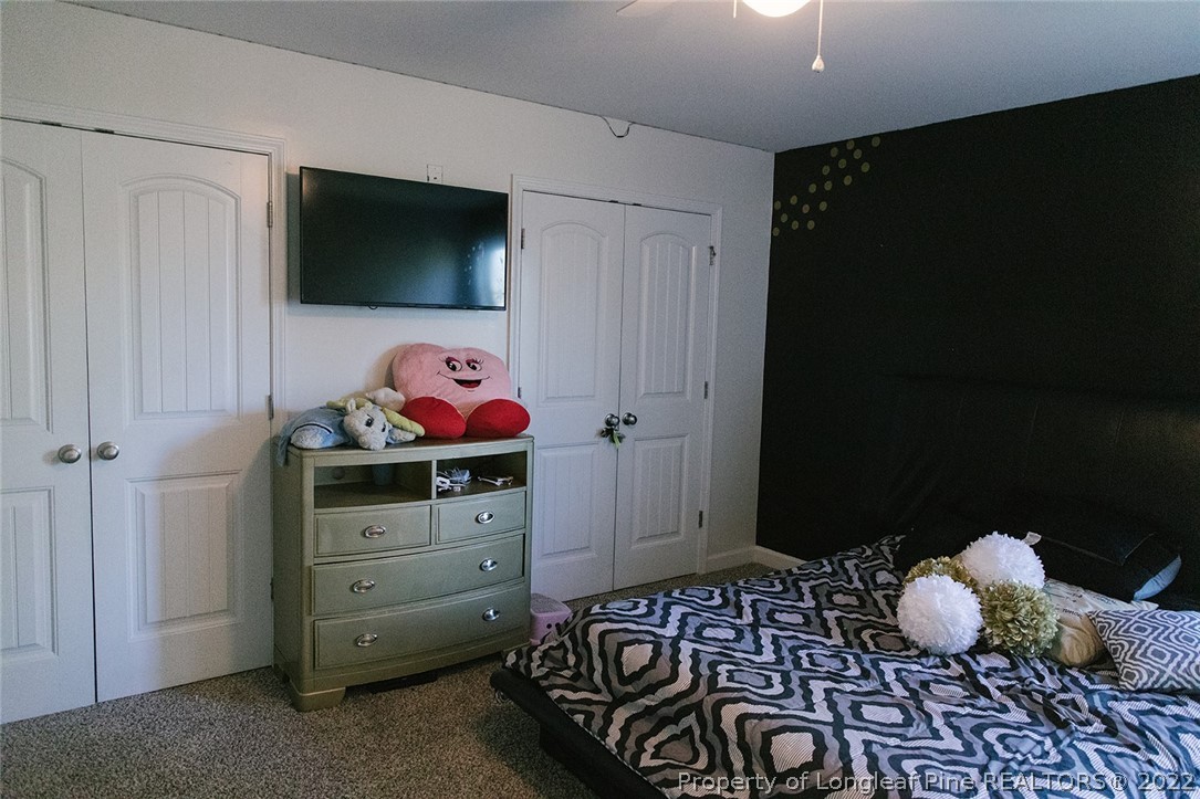 153 Shellbark Drive Spring Lake, NC 28390 - Photo 42 of 48 a bedroom with a bed and flat screen tv