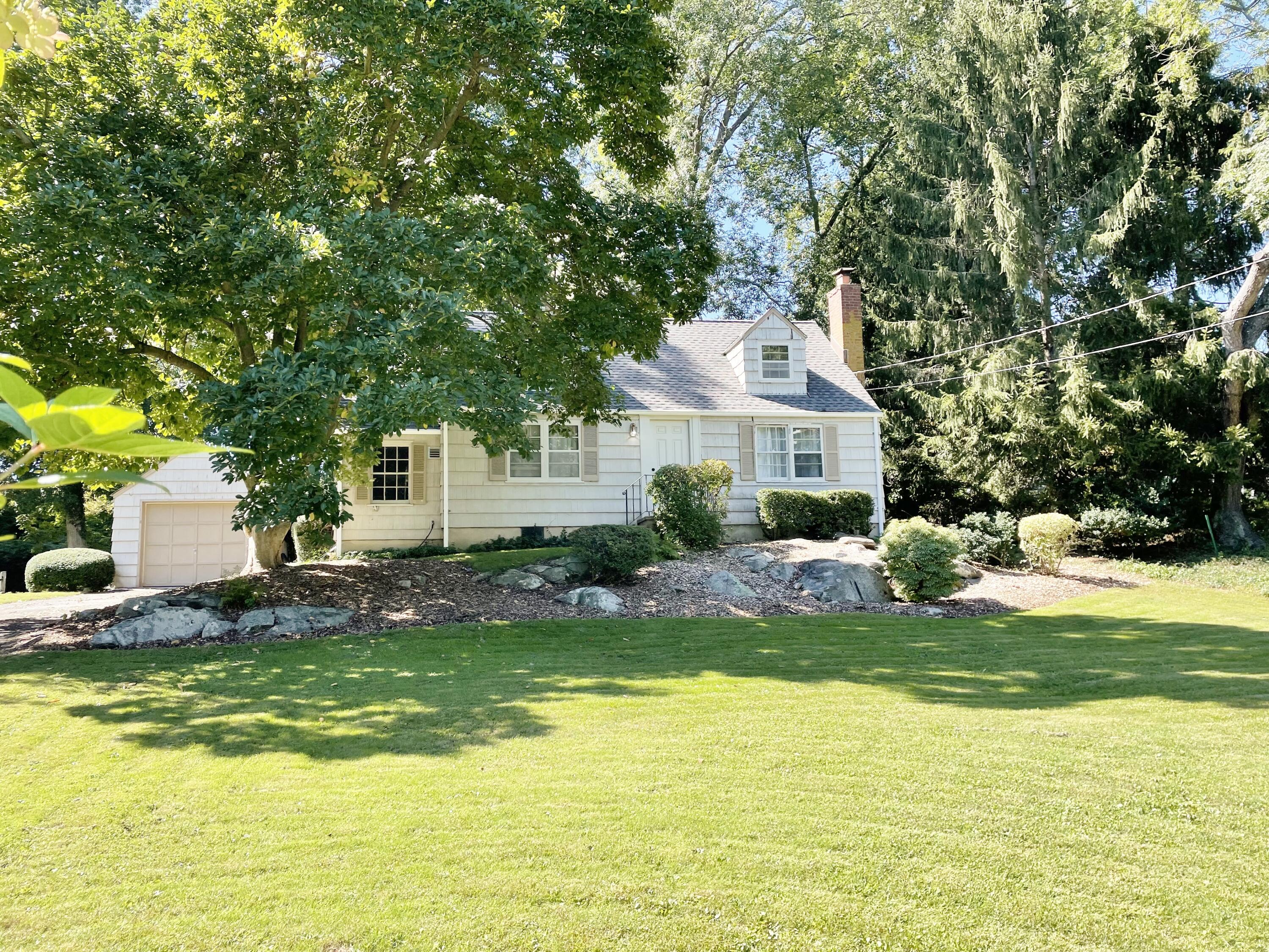 16 Burchard Lane Rowayton, CT 06853 - Photo 2 of 22 a front view of a house with a yard