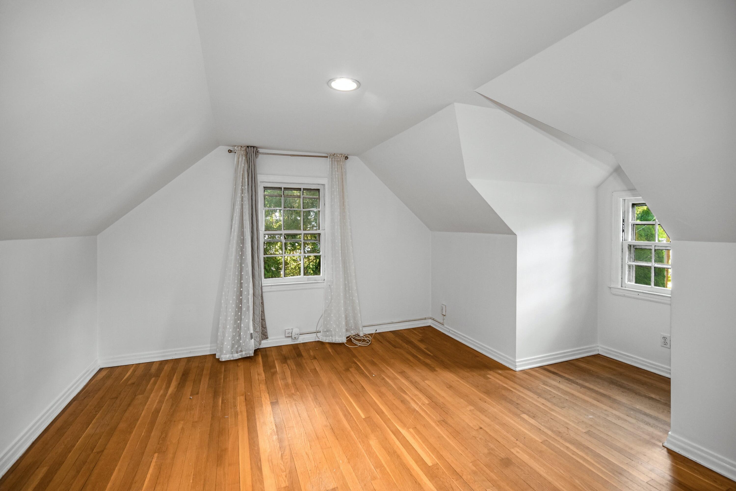 16 Burchard Lane Rowayton, CT 06853 - Photo 16 of 22 an empty room with wooden floor and windows