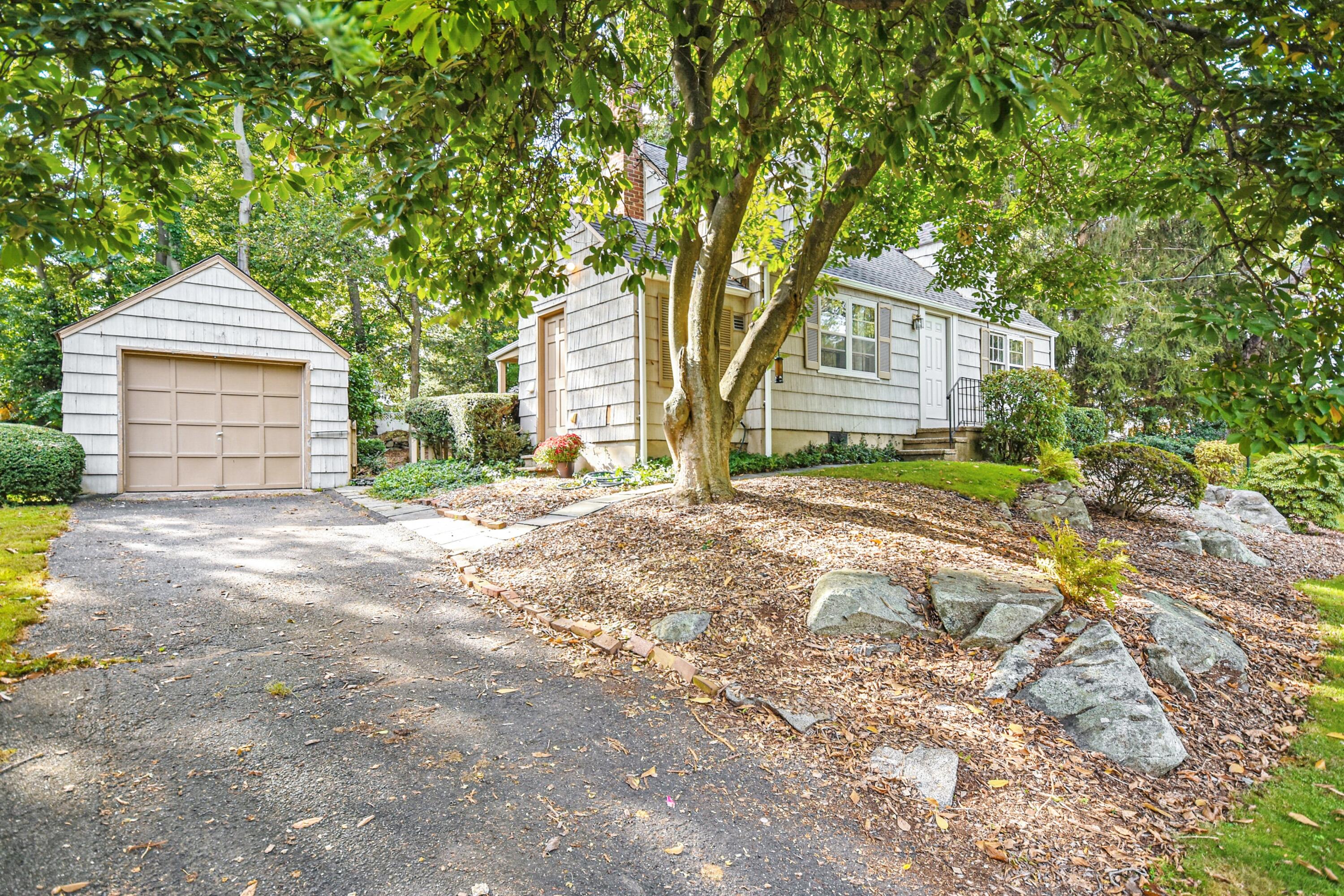 16 Burchard Lane Rowayton, CT 06853 - Photo 4 of 22 a front view of a house with a yard and garage