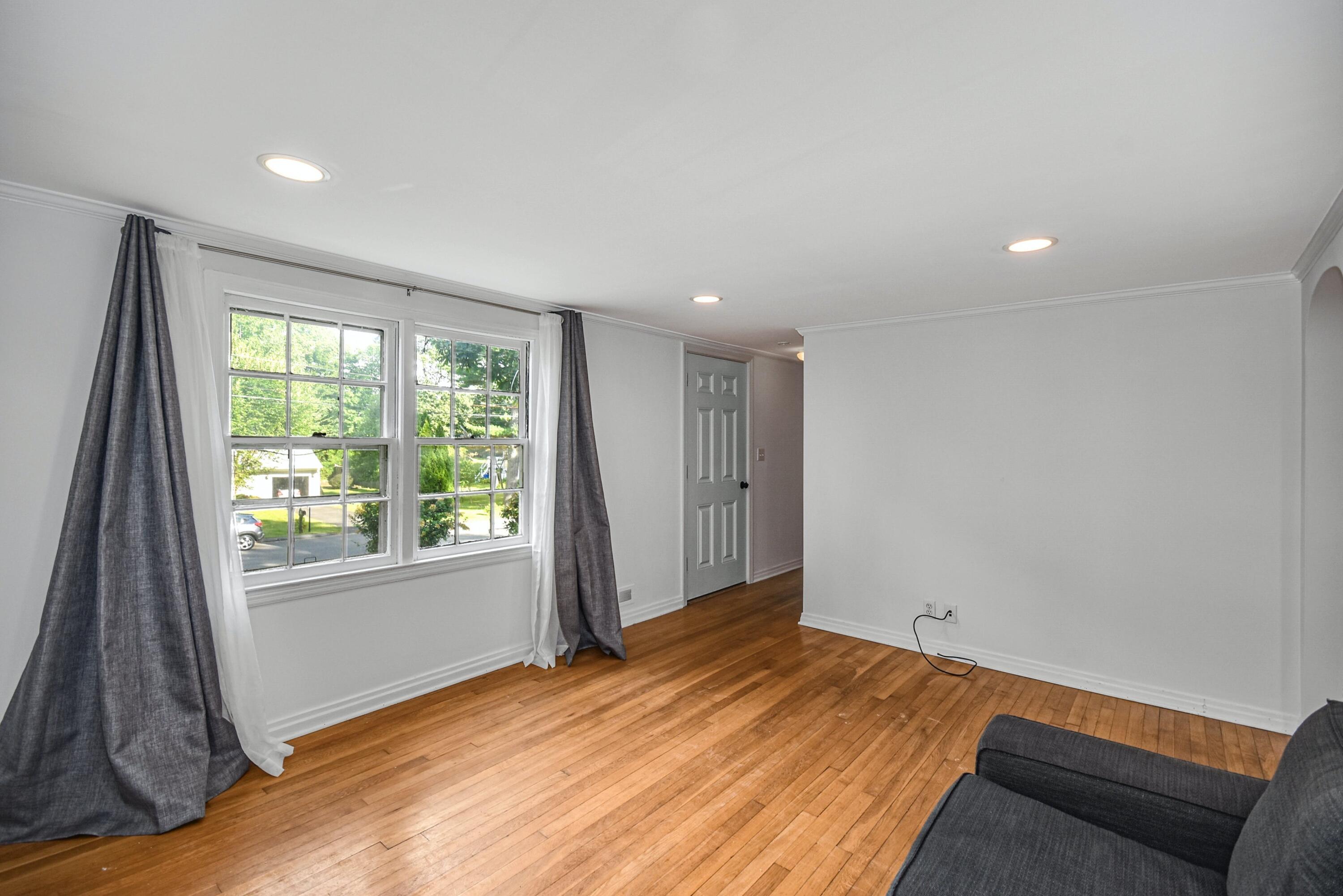 16 Burchard Lane Rowayton, CT 06853 - Photo 9 of 22 a view of empty room with wooden floor and fan