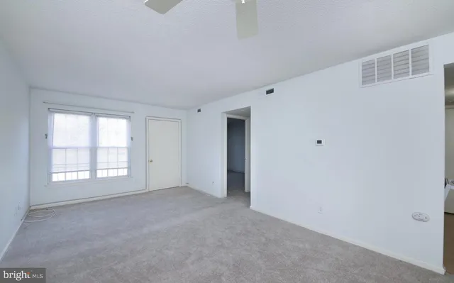 a view of an empty room with a window