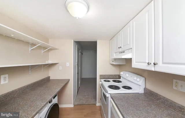 a kitchen with stainless steel appliances granite countertop a sink and a stove